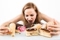 Glutton woman eating cupcakes with frenzy after long diet