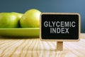 Glycemic index GI concept. Nameplate and plate with apples Royalty Free Stock Photo