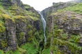 Glymur waterfall in Iceland, in a large mossy canyon