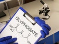 Glyphosate is shown using the text and formula. Glyphosate - molecule of non-selective systemic herbicide used for weed control Royalty Free Stock Photo