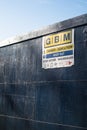 GMB Demolition danger keep out sign on a large blue solid fence wall with blue sky behind