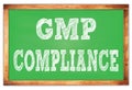 GMP COMPLIANCE words on green wooden frame school blackboard