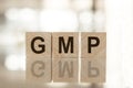 GMP word written on wood block with surface mirror background Royalty Free Stock Photo