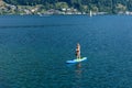 GMUNDEN, AUSTRIA, - AUGUST 03, 2018: Aerial view. Young Woman on Paddle Board at the lake. SUP. Royalty Free Stock Photo