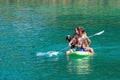 GMUNDEN, AUSTRIA, - AUGUST 08, 2018: Family with dog on Paddle Board at the lake. SUP. Royalty Free Stock Photo