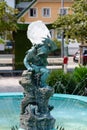 GMUNDEN, AUSTRIA, - AUGUST 03, 2018: Fountain and tatue the Gnome by artist Heinrich Natter in Gmunden, Austria. Royalty Free Stock Photo