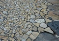 Natural paving of gneiss and granite irregular stones folded into a beautiful pattern where larger stones are surrounded by small