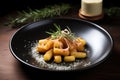 gnocchi in brown butter on a dark plate