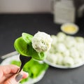 Gnocchi with fresh spinach on the fork in female hand