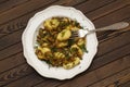 Gnocchi with a mushroom sauce and fresh herbs on a white plate