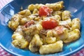Gnocchi with pesto and fresh tomatoes Royalty Free Stock Photo