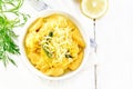 Gnocchi pumpkin with lemon in bowl on light board top