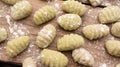 Gnocchis on a wooden dock with flour on them