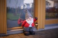 Gnome figure standing near an entrance door