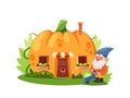 Gnome Gardener near the Fairytale Pumpkin House, Fairytale Home In Ripe Orange Gourd With Wooden Door, Windows Royalty Free Stock Photo
