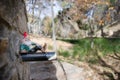 Gnome lying on a water spout from a fountain found in a forest with autumn colors in Sierra de Huetor Royalty Free Stock Photo