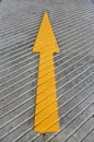 Go ahead arrow. Yellow Arrow signs as road markings. Arrow sign on slope floor at park building Royalty Free Stock Photo