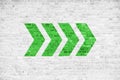 Go ahead green directional arrow signs pointing direction painted on a white gray brick wall signboard texture background Royalty Free Stock Photo