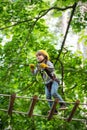 Go Ape Adventure. Climber child on training. Child climbing on high rope park. Children fun. Cargo net climbing and