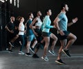 Go as fast as your legs can carry you. a group of people jogging together at the gym. Royalty Free Stock Photo