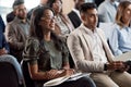 Go beat the game, young control freak. a group of businesspeople taking notes during a meeting in an office.