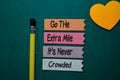 Go The Extra Mile It`s Never Crowded write on stick note isolated on Office Desk Royalty Free Stock Photo