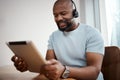 Go the extra mile for your clients, or someone else will. a man using a digital tablet while working in a call center.