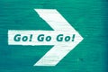 `Go! Go Go!` text written on a white directional arrow