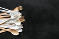 Plastic flatware, forks, spoons, knifes for eco and Earth protection concept on black background top view mockup Royalty Free Stock Photo