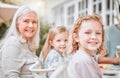 Go home and love your family. two girls and their grandma sitting at a tablet at home.