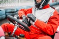 Go-kart driver in helmet on karting speed track