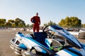 Go-kart driver walking to car before race at starting line Royalty Free Stock Photo