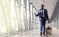 Go on plane. Businessman carrying luggage, moving to boarding gate in Airport Royalty Free Stock Photo