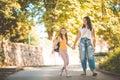 Little school girl walking with mom trough nature Royalty Free Stock Photo