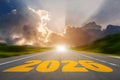 Go to the New Year 2022 concept. Bright road leading to the year 2026 with sunlight breaking through the clouds, symbolizing hope Royalty Free Stock Photo