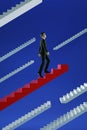 Go to success. Businessman climbs a red flying stairs.