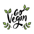 Go vegan hand lettering with green leaf.