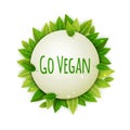 Go vegan round banner with realistic green leaves