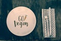 Go vegan text healthy eating on rustic wood table