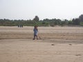 GOA, INDIA, 03.03.2020 A cleaner on the beach collects garbage. The concept of caring for the environment