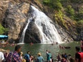 Goa, India - December 6, 2018: Beautiful view of Dudhsagar mountain waterfall. People swim near the waterfall, admire nature and