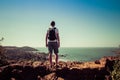 Goa, India - December 20, 2018: man stands on a high cliff looking at the beach Vagator