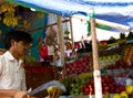 Goa, India - December 16, 2016: A roadside fruit vendor prepares a green coconut for consumption