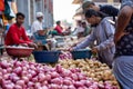 Goa, India, February 2023. Close-up of stalls full of fresh potatoes, red onions at Indian outdoor local street market. Royalty Free Stock Photo