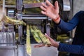 Goa, India, February 2023. Cropped photo of man seller vendor showing machine mechanical device extracting sugarcane. Royalty Free Stock Photo