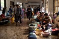 Goa, India, February 2023. Group of different sellers sitting near seafood stalls, selling and cleaning fresh raw fish.