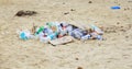 Large garbage dump waste of plastic bottles on the sand