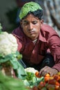 Goa, India - February 2008 - Young man selling fresh vegetables at the famous Mapusa Market