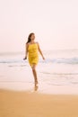 Goa, India. Young Caucasian Woman In Yellow Dress Walking On Seashore And Enjoying Life In Summer Sunlight Royalty Free Stock Photo