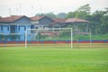 A goal on an artificial track and field with green grass combined with artificial grass